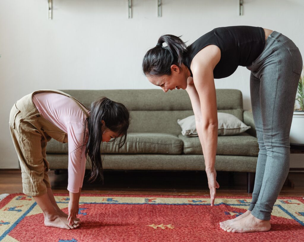 Woman doing yoga with child